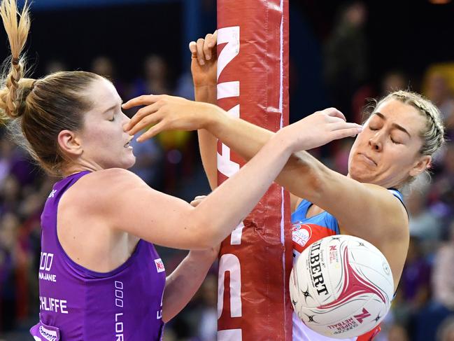 Tara Hinchliffe of the Firebirds (left) and Sophie Garbin of the Swifts collide with the goal post while contesting the ball during the Round 8 Super Netball match between the Queensland Firebirds and the NSW Swifts at the Brisbane Entertainment Centre in Brisbane, Sunday, June 24, 2018. (AAP Image/Darren England) NO ARCHIVING, EDITORIAL USE ONLY