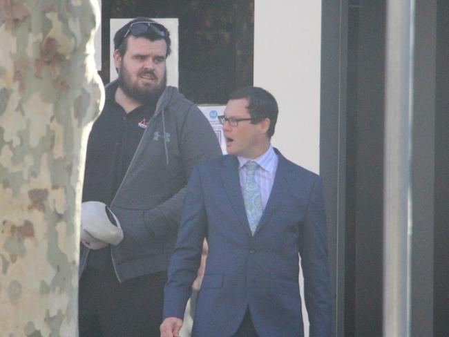 Daniel Hudson (left) leaves court after pleading guilty to making racial slurs against South Sydney Rabbitoh Latrell Mitchell. Picture: Fiona Killman