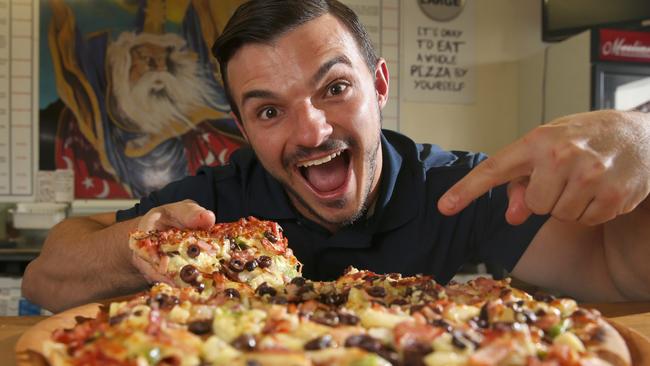 Scott Jelich of Merlins Pizza with Excalibur, one of their signature pizza. Photo: Regi Varghese