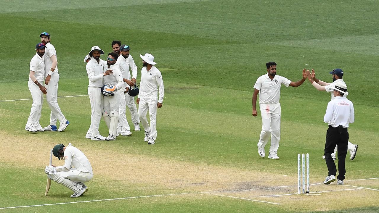 Nathan Lyon crouches after the final wicket falls in Adelaide.