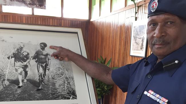 PNG Police Chief Inspector Lincoln Gerari, 62, points to his grandfather Raphael Oimbari, in the iconic WW2 photo by George Silk of a Fuzzy Wuzzy Angel helping wounded Private George Whittington to safety. Picture: Supplied