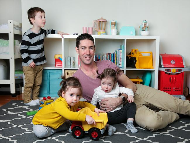 NAB analyst engineer Leif Pedersen at home with children Will, 3, and twins Margot and Frankie, 18 months. Picture: Ian Currie