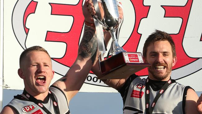 Roxburgh park captain Harley Short and coach Michael Farrelly show off the silverware. Picture: Hamish Blair