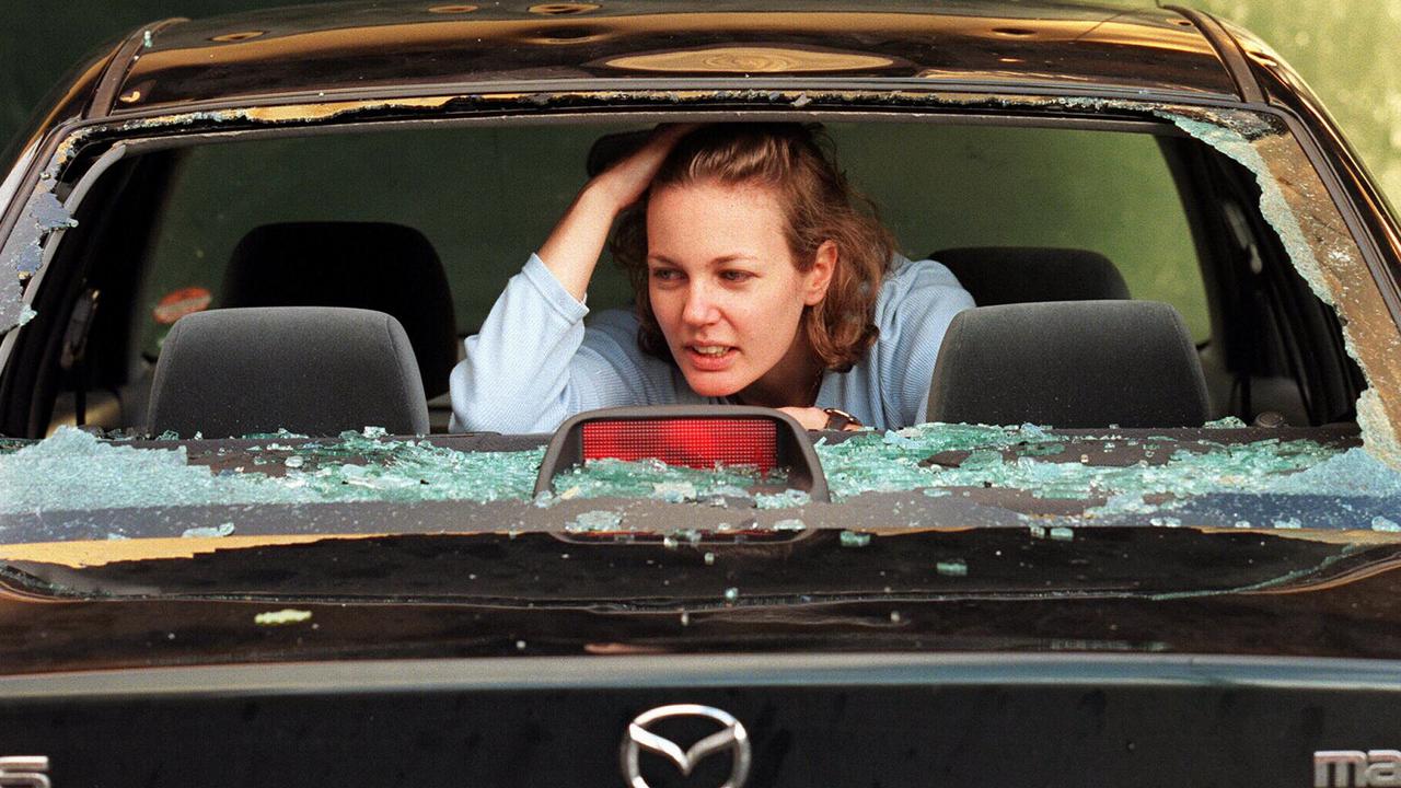 Sydney resident Claire Reynolds and destroyed motor car windscreen following a freak overnight hailstorm that destroyed roofs, car windscreens and cut power to homes 15 Apr 1999. hail storm /Storms