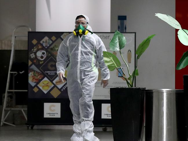 A person believed to have presented with Covid-19 symptoms to a doctors surgery in the Cabramatta Plaza with cleaners sanitizing the area inside. Picture: Toby Zerna