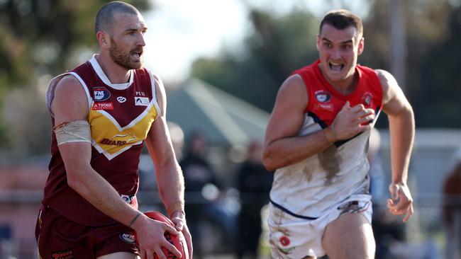 NFL: Lower Plenty’s Darcy Barden runs away from Jai Norman of Diamond Creek. Picture: George Sal