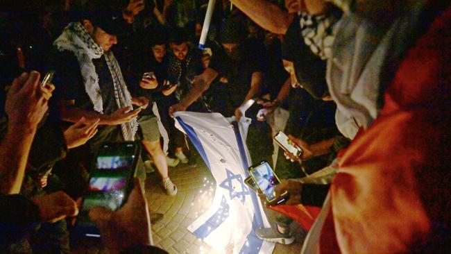 Rally for a Free Palestine protesters burnt the Israeli flag on the forecourt of the Sydney Opera House on October 9 2023. Picture: NCA NewsWire / Jeremy Piper