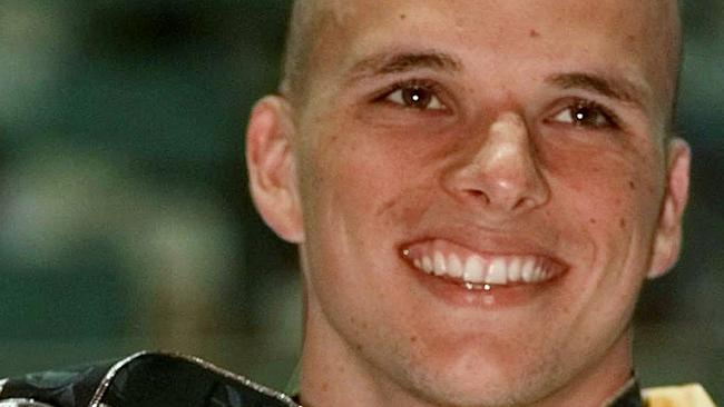 Scott Miller of Australia holds up his silver medal that he won in the men's 100 meter butterfly at the 1996 Summer Olympics in Atlanta, in this July 24, 1996 file photo.  (AP Photo/Denis Paquin,file)