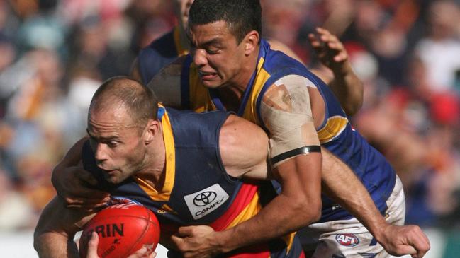 Jason Torney is tackled by Daniel Kerr.