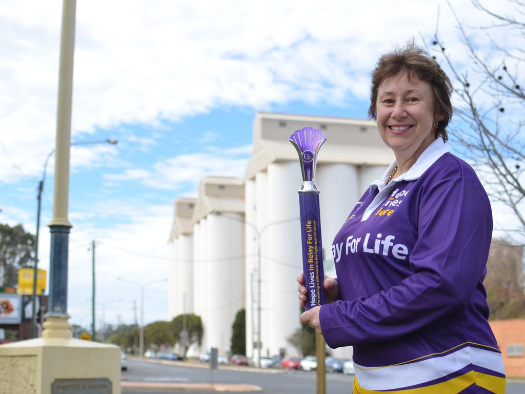 Relay for Life chair Rowena Dionysius with the relay torch that has passed through towns across Queensland.