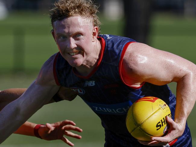 MELBOURNE , AUSTRALIA.February 12 , 2024.  Melbourne AFL football training at Goschs Paddock. Clayton Oliver of the Demons  fends off Koltyn Tholstrup  . Pic: Michael Klein