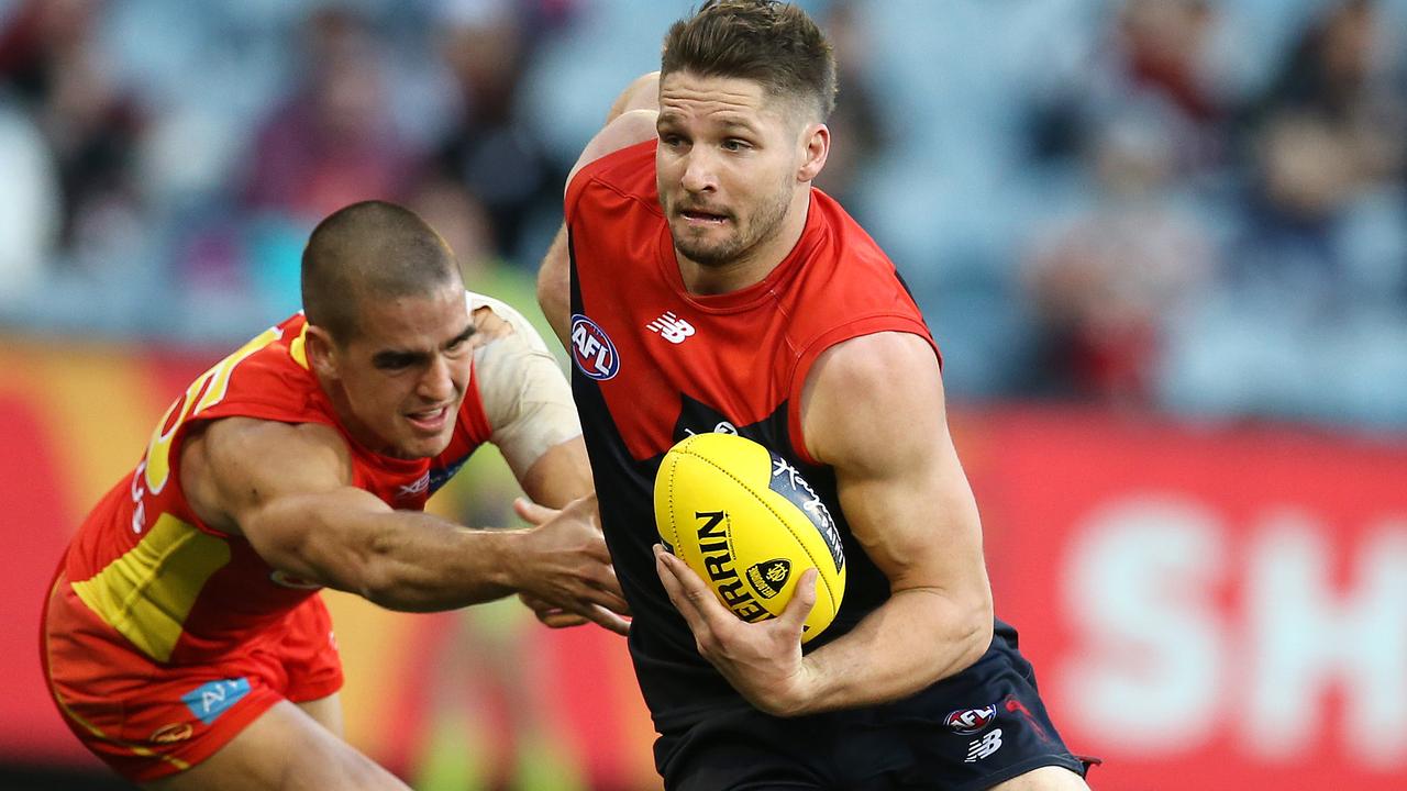 AFL Round 20. 05/08/2018. Melbourne v Gold Coast Suns at the MCG.  Melbourne's Jesse Hogan breaks the tackle of Gold Coast Suns' Jacob Dawson  .Pic: Michael Klein