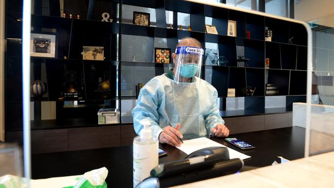 Healthcare staff prepare the hotel for returned overseas travellers. Picture: Andrew Henshaw