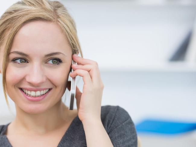 Close-up of business woman using mobile phone in office