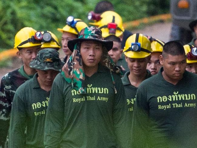 Thai soldiers walk out from the Tham Luang cave area as operations continue for the 8 boys and their coach trapped at the cave in Khun Nam Nang Non Forest Park in the Mae Sai district of Chiang Rai province on July 9, 2018. Four boys among the group of 13 trapped in a flooded Thai cave for more than a fortnight were rescued on July 8 after surviving a treacherous escape, raising hopes elite divers would also save the others soon. / AFP PHOTO / YE AUNG THU