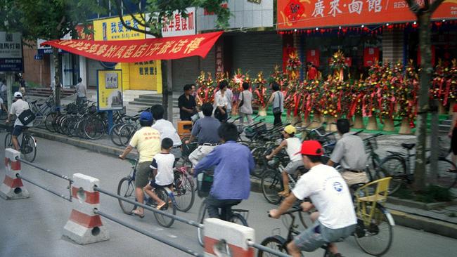 03/12/2001. Chinese people riding bikes in Hangzhou City, China. (Pic: Stuart Innes)