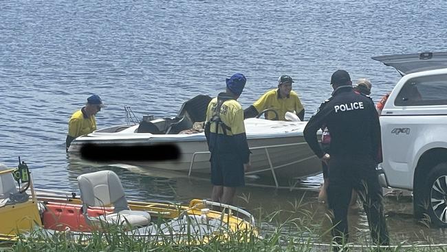 Emergency services bring the family's boat ashore at Kinchant Dam.