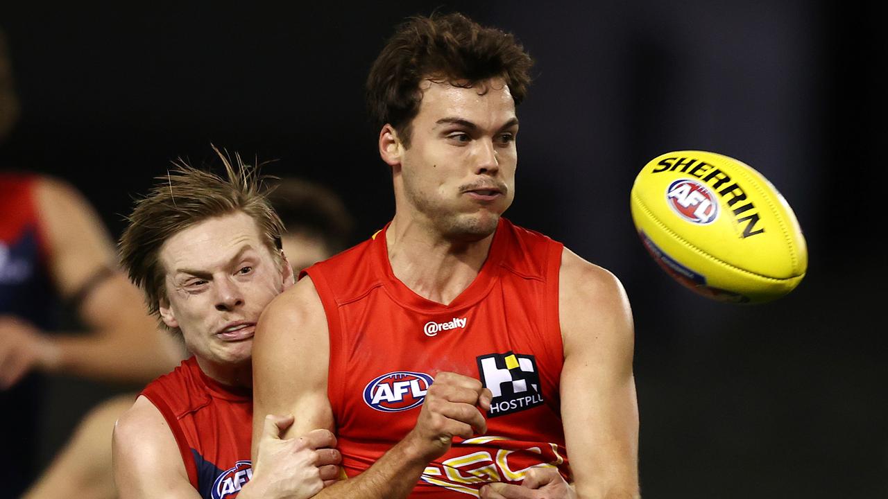 AFL Round 20. Gold Coast Suns v Melbourne at Marvel Stadium, Melbourne. 01/08/2021. Jack Bowes of the Suns clears as he is tackled by Charlie Spargo of the Demons during the 1st qtr. . Pic: Michael Klein