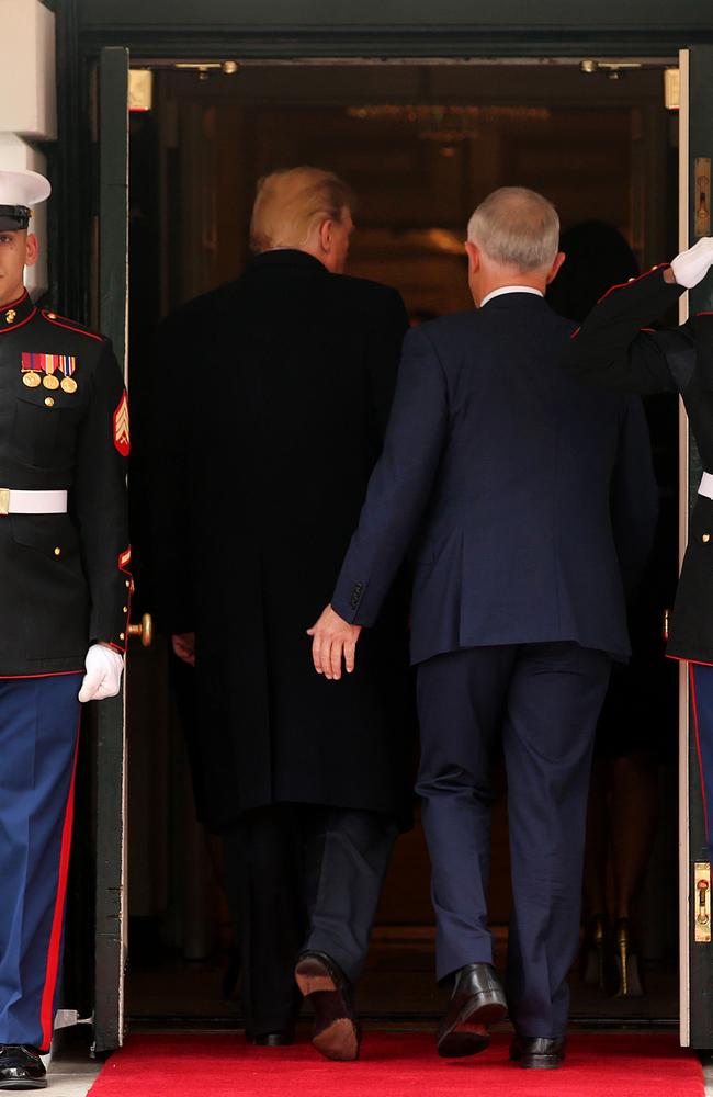 After you. Malcolm Turnbull allows Donald Trump rite of passage as they enter the White House. Picture: Nathan Edwards