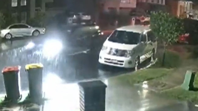 In CCTV obtained by Channel 9, the black SUV is seen allegedly driving along Steeple Pl in the pouring rain, before two men get out and pepper the target house in bullets. Picture: Supplied / Channel 9