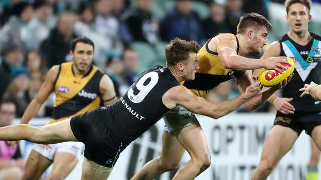 Robbie Gray lays a strong tackle on Richmond’s Anthony Miles. Picture: Calum Robertson