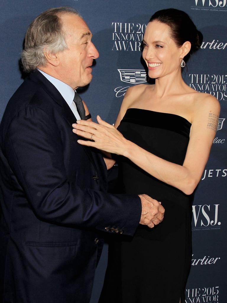 Robert De Niro kisses honoree Angelina Jolie Pitt at the WSJ. Magazine 2015 Innovator Awards at the Museum of Modern Art on November 4, 2015 in New York City. Picture: AP