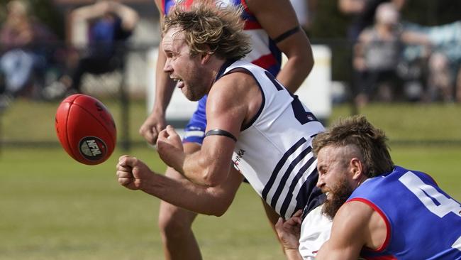 Bundoora veteran Brent Marshall gets a handball away. Picture: Valeriu Campan