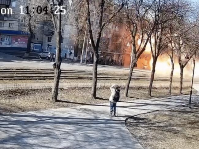 Video shows a bystander in the foreground look up at the sky, and moments later, the bus explodes.