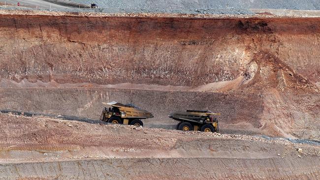 Earth movers pass each other at OZ Minerals’ Prominent Hill mine. Picture: Getty Images