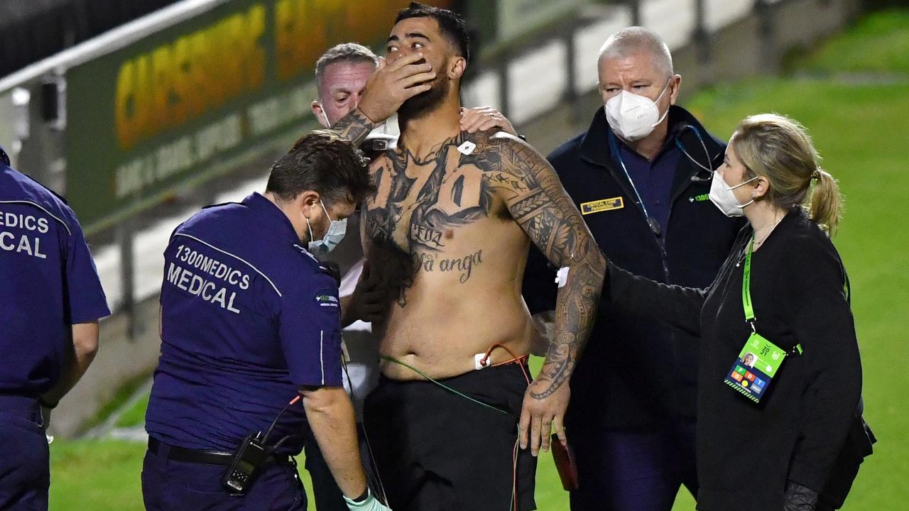 Andrew Fifita of the Sharks is seen surrounded by medical staff on the field at Moreton Daily Stadium in Redcliffe. (AAP Image/Darren England)