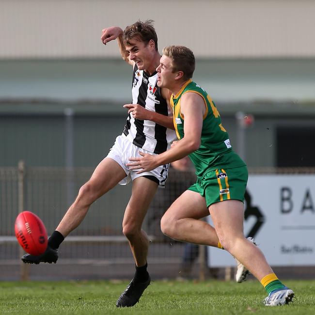 Leongatha’s Jenson Garnham bumps Sale opponent Hudson Holmes, Picture: Yuri Kouzmin