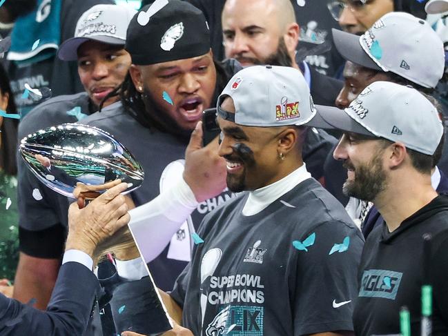 NEW ORLEANS, LOUISIANA - FEBRUARY 09: Philadelphia Eagles owner Jeffrey Lurie hands the Vince Lombardi Trophy to Jalen Hurts #1 after beating the Kansas City Chiefs 40-22 to win Super Bowl LIX at Caesars Superdome on February 09, 2025 in New Orleans, Louisiana. (Photo by Chris Graythen/Getty Images)