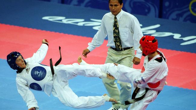 Paul Lyons, left, competing against Morocco’s Vounes Sekkat at the Sydney Olympics in 2000. Picture: Scott Radford Chisholm.