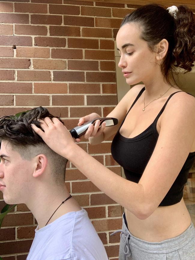 Victoria's Secret model Sarah Stephens gives her brother a haircut.