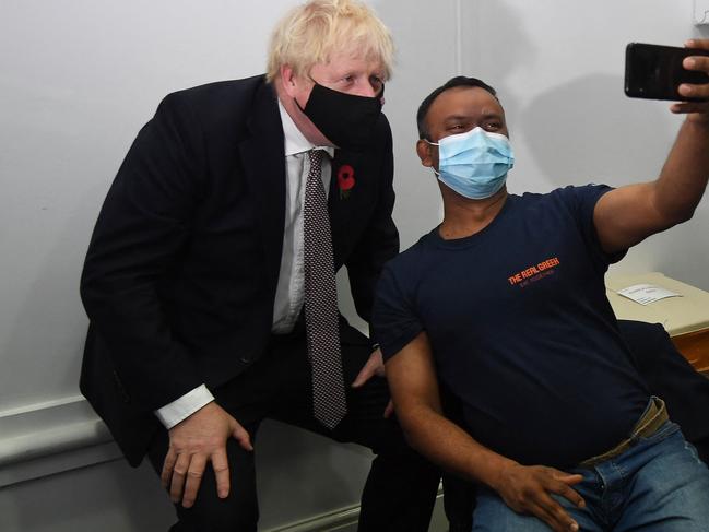 A man takes a selfie with Bosris Johnson after receiving his booster shot. Picture: AFP