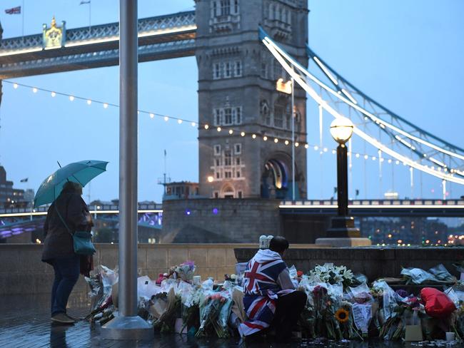 Mourners lay flowers at Potters Fields Park in London after a vigil to commemorate the victims of the terror attack. Picture: AFP