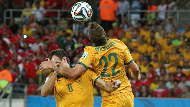 Friends... to foes: Australia's Matthew Spiranovic collides with Australia's Alex Wilkinson. They go head to head on Sunday. Pic: George Salpigtidis