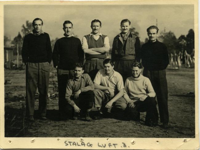 Gone but never forgotten: Squadron Leader James Catanach (kneeling, right), who will be commemorated at the Australian War Memorial on the 80th anniversary of the Great Escape, with fellow prisoners of war at Stalag Luft III.