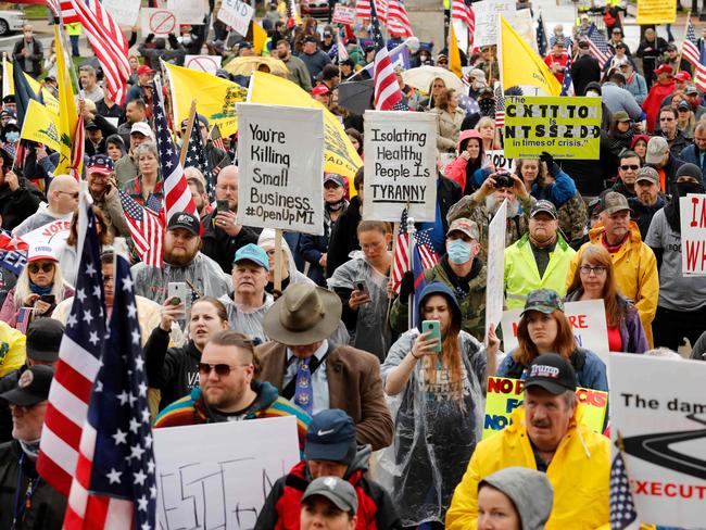 Demonstrators take part in an "American Patriot Rally," organized on April 30, 2020, by Michigan United for Liberty on the steps of the Michigan State Capitol in Lansing, demanding the reopening of businesses. - The group is upset with Michigan Gov. Gretchen WhitmerÕs mandatory closure to curtail Covid-19. (Photo by JEFF KOWALSKY / AFP)