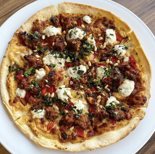 Smokin’ Joe's Rahman pizza is topped with hummus, harissa spiced lamb kofta, roasted red peppers, manchego cheese, garlic yoghurt sauce, pine nuts, lemon, parsley and mint. Picture: Instagram @smokinjoesbar