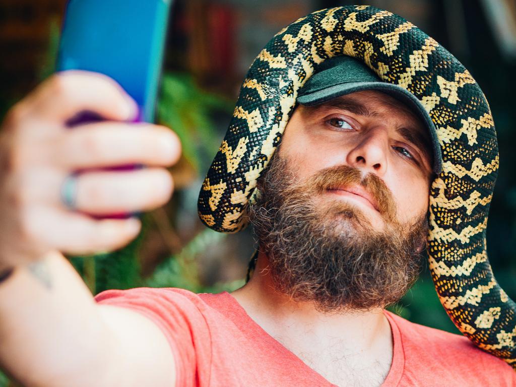 Taking a selfie with a snake is a thing.