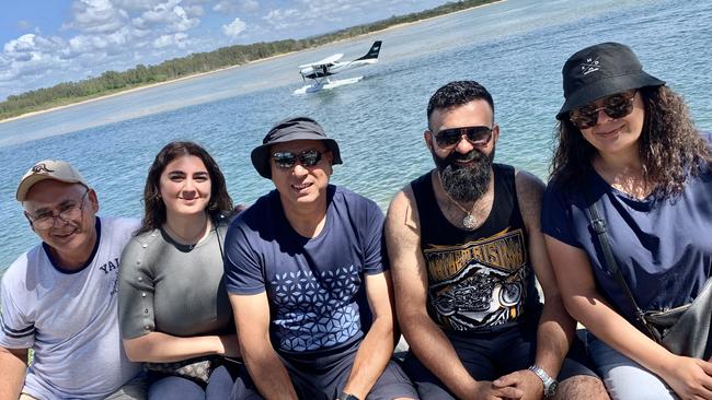 The Jaafar family – Taleb, Mallak, Nick, John and Armani – from The Hills district in Sydney on holiday in Port Macquarie waiting to board the Eastern Air Services adventure seaplane (pictured behind). Picture: Janine Watson