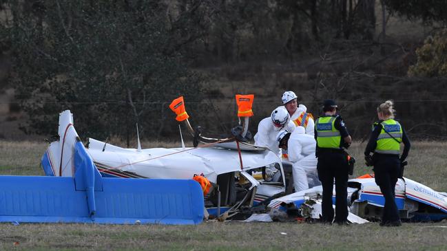 Investigators gather evidence from a mangled plane. Picture: AAP Image/James Ross