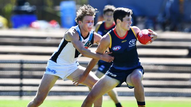 Power draftee Xavier Duursma, tackles Adelaide’s Chayce Jones in the pre-season practice match.