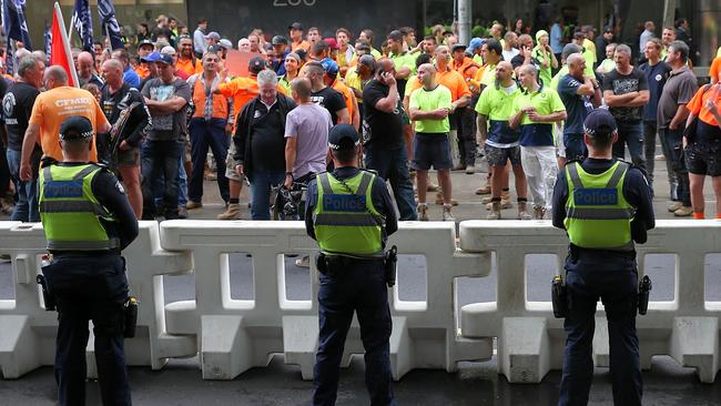 Police keep CFMEU workers away from the Melbourne Magistrates Court ahead of the court hearing for the CFMEU bosses. Picture: Ian Currie