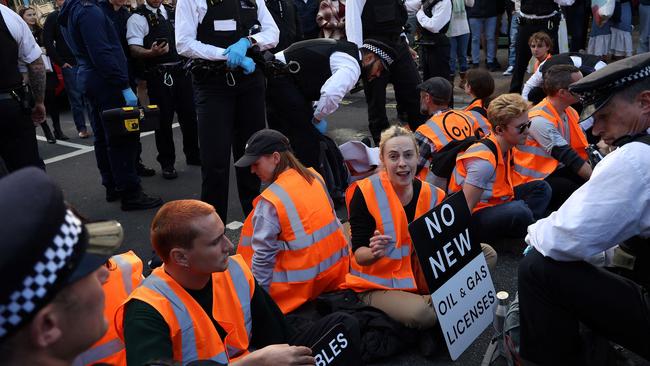 Protesters, some with their necks padlocked together, block the road as they take part in a demonstration by Just Stop Oil climate activists at Piccadilly Circus London. Picture: Isabel Infantes/AFP