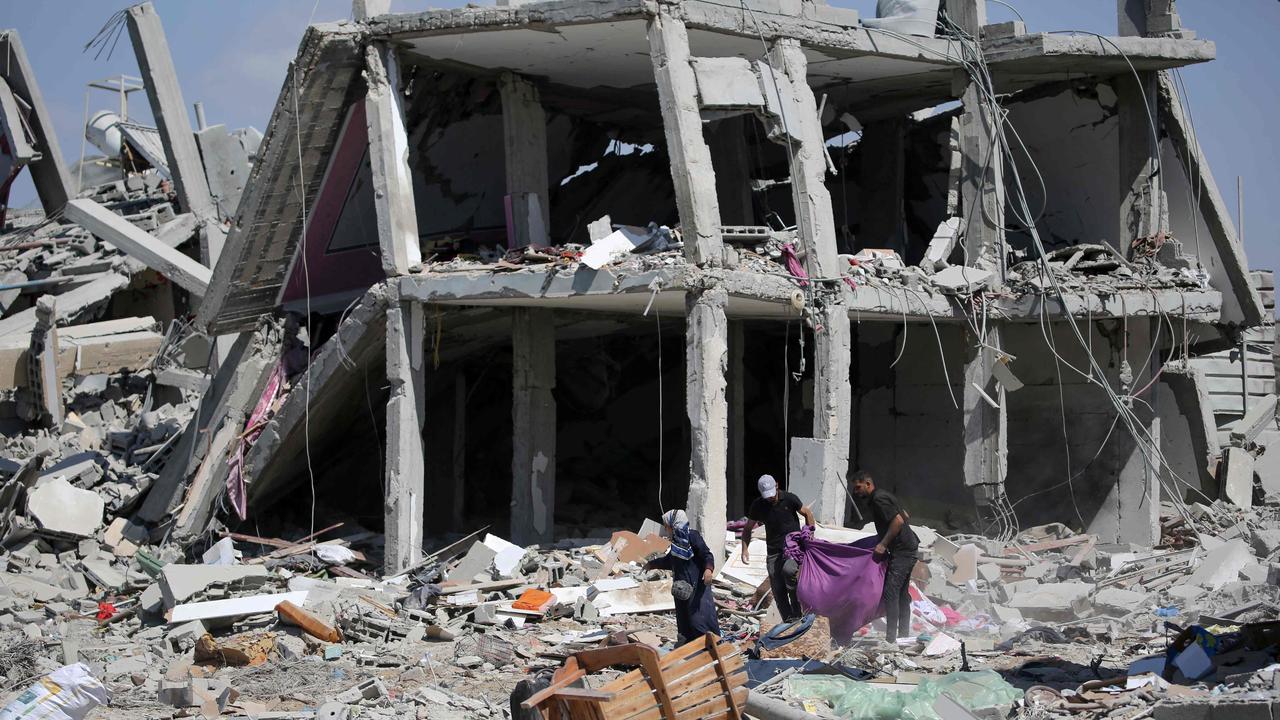 Palestinians who returned briefly to eastern Deir al-Balah in central Gaza Strip to check on their homes after Israeli airstrike. Picture: AFP.