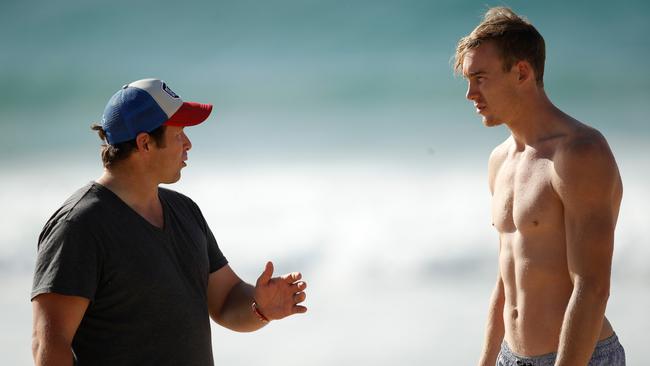 Gold Coast coach Stuart Dew and Lynch speak on the beach in July last year. The then-Suns gun was contemplating his departure. Picture: AFL Media