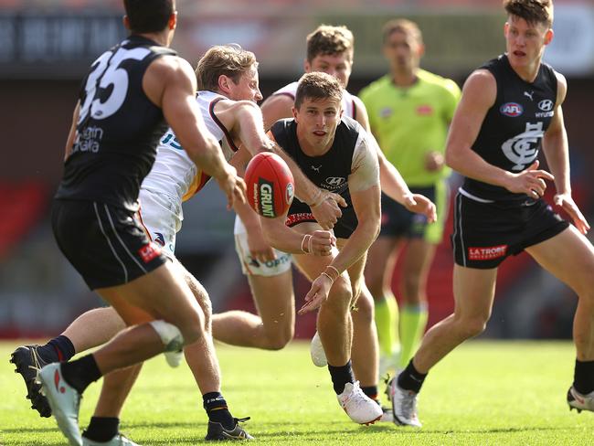 Marc Murphy handballs as the Blues comes up short against the Adelaide Crows.