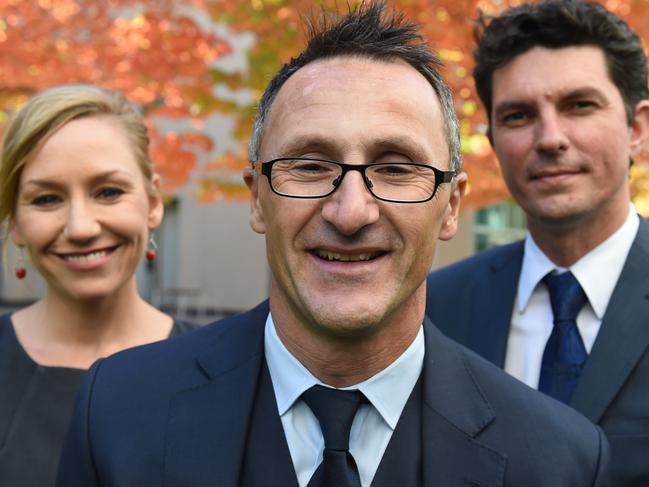 **FILE** A Wednesday, May 6, 2015 image reissued Friday, July 14, 2017 of Australian Greens senator Scott Ludlam (right) with Greens Leader Richard Di Natale (centre) and Senator Larissa Waters (left) at a photo opportunity after Christine Milne resigned as Greens leader at Parliament House in Canberra. Australian Greens senator Scott Ludlam is leaving federal parliament after finding out he is ineligible to hold office. The party's co-deputy leader said it was recently brought to his attention that he holds dual citizenship of Australia and New Zealand, making him ineligible. (AAP Image/Mick Tsikas) NO ARCHIVING